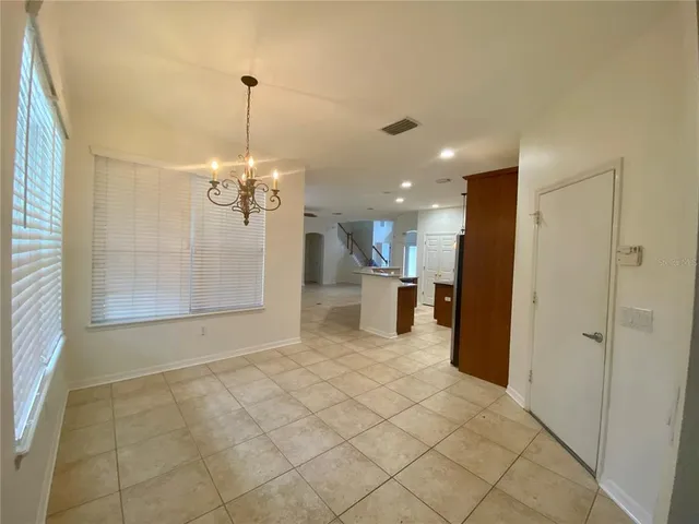 a view of a hallway with a chandelier