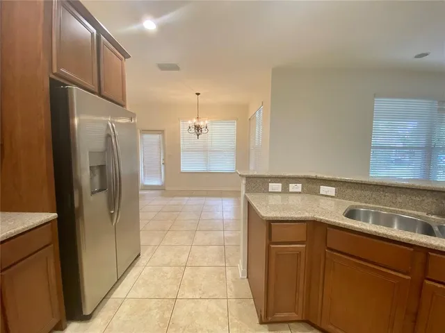 a kitchen with a sink and refrigerator