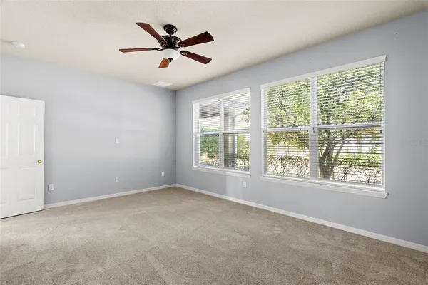 a large kitchen with a sink and dishwasher with white cabinets