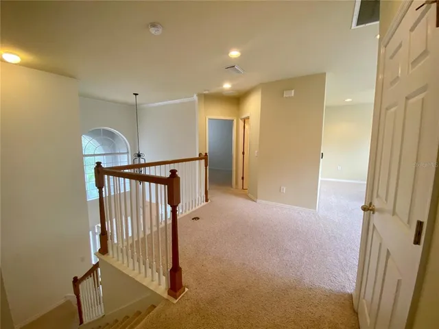 a view of a hallway with entryway door front door