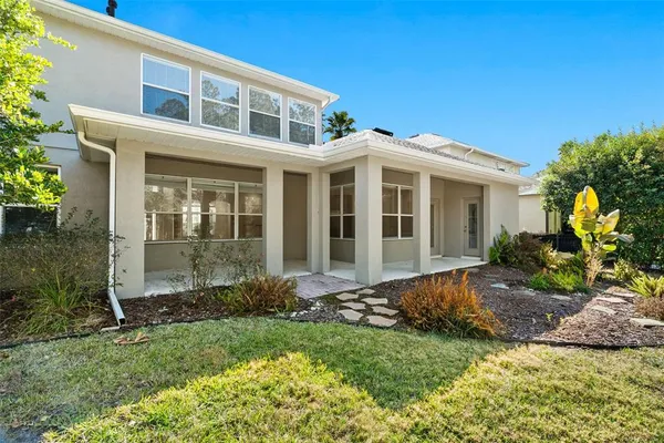 a view of a house with swimming pool and yard