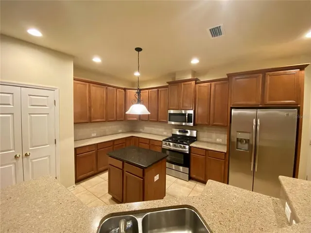 a kitchen with a refrigerator a sink and a stove