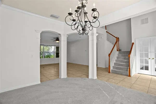 a view of kitchen with windows and refrigerator