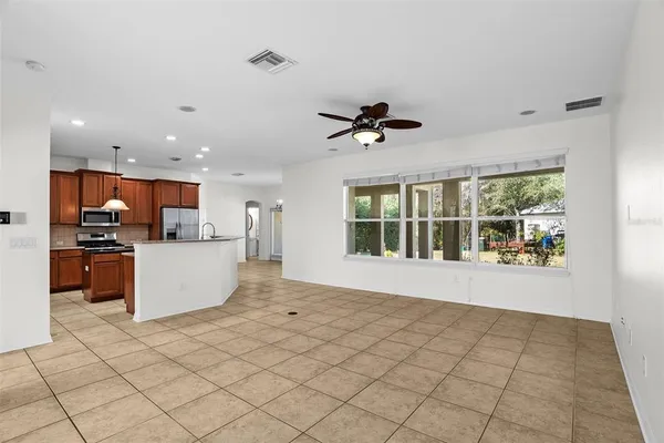 a view of a kitchen with furniture and a ceiling fan