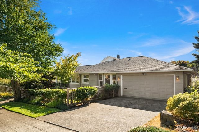 a front view of a house with plants