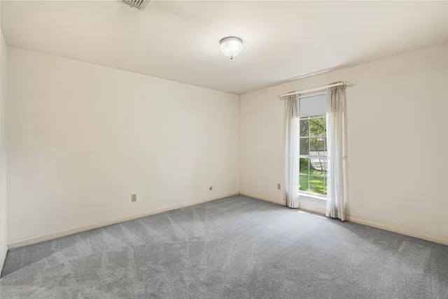 an empty room with a empty space and a window