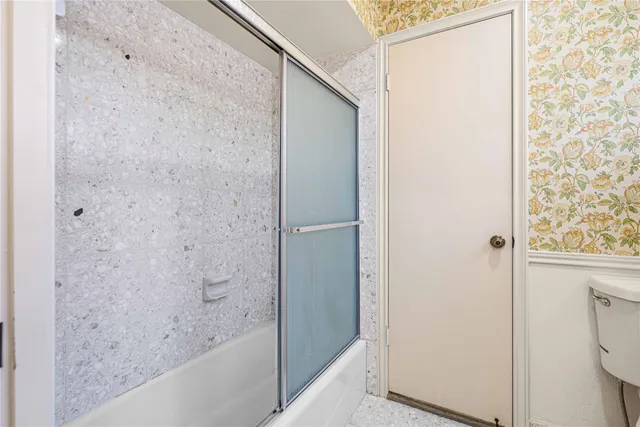 a bathroom with a bathtub and shower