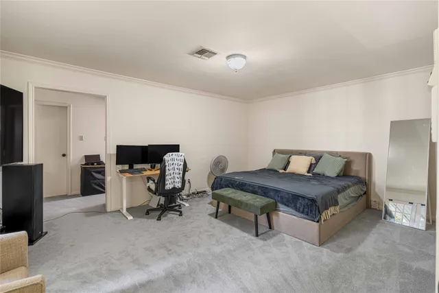 a spacious bedroom with a bed and a chair