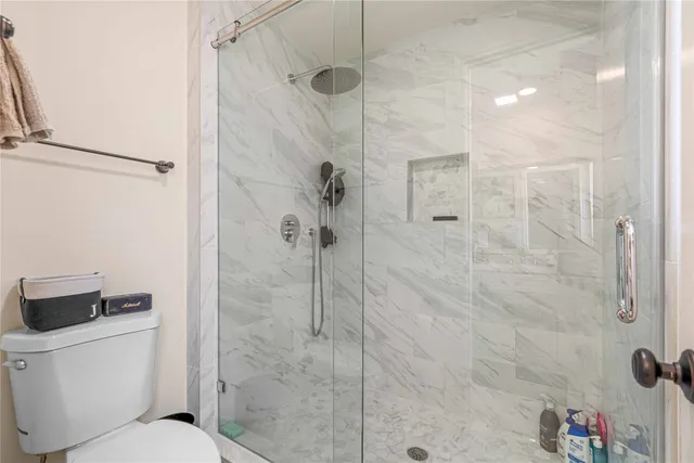 a white toilet sitting next to a bathroom sink