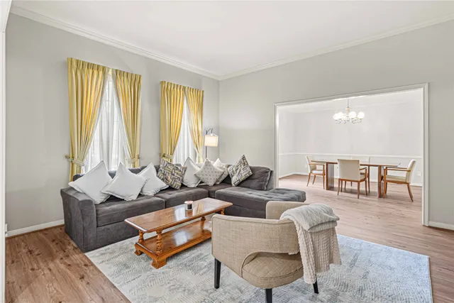 a living room with furniture and floor to ceiling windows