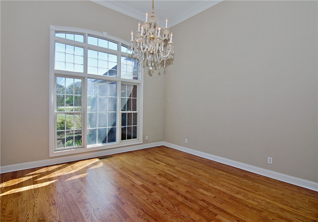 7893 Athens Road Carnesville, GA 30521 - Photo 6 of 50 This airy room features hardwood floors, crown molding, and a sparkling chandelier, all bathed in natural light.