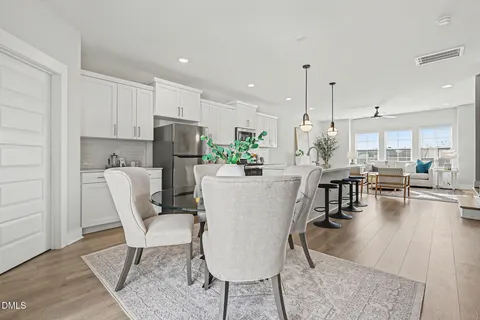 a dining room with furniture and a window