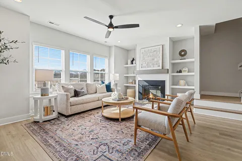 a kitchen with stainless steel appliances granite countertop a refrigerator a stove oven a sink dishwasher and white cabinets with wooden floor