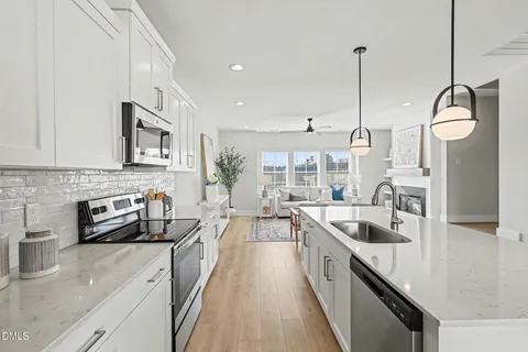 a kitchen with stainless steel appliances white cabinets and a sink