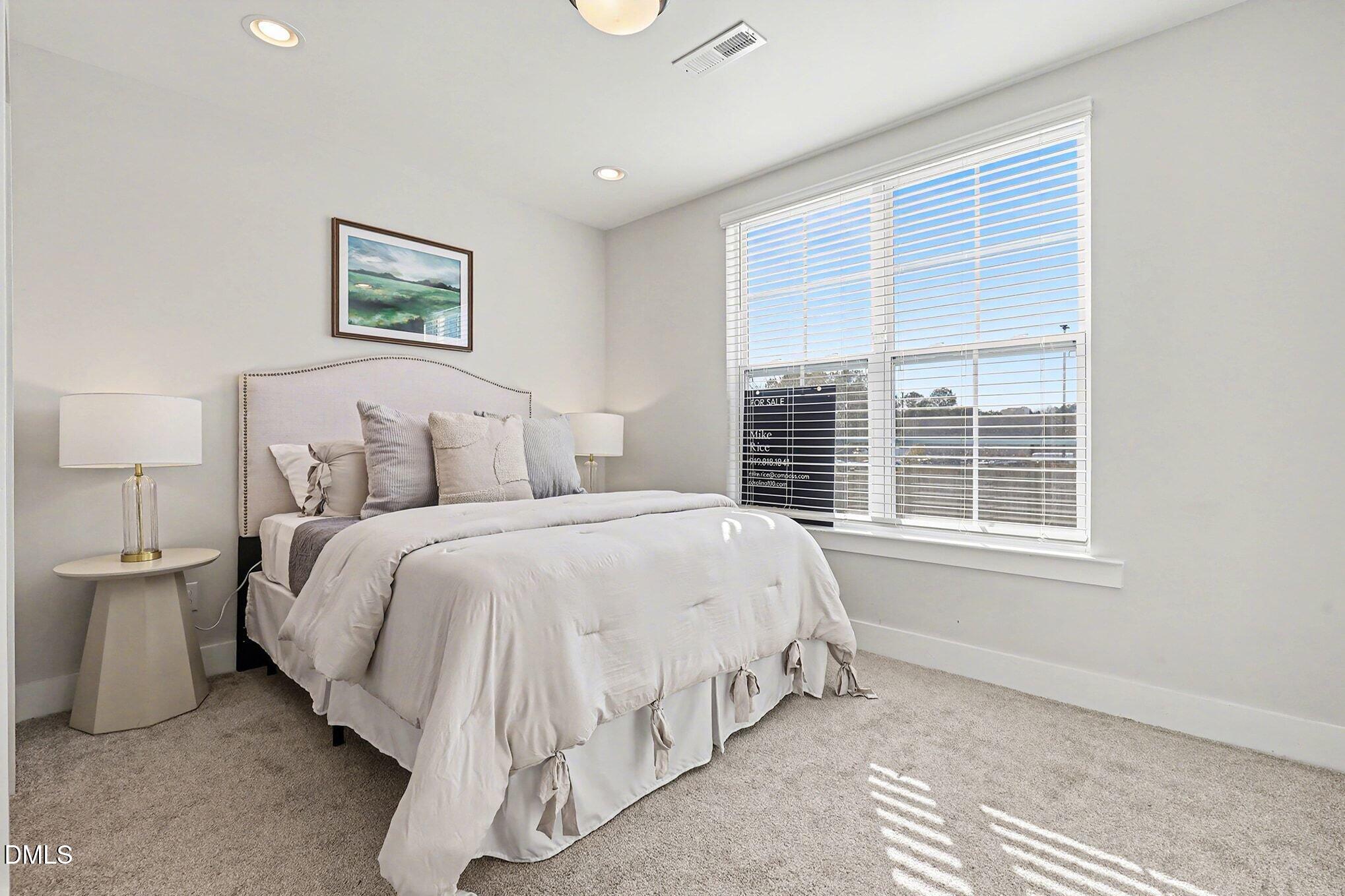 8512 Silsbee Drive Raleigh, NC 27613 - Photo 4 of 42 a spacious bedroom with a bed and a window