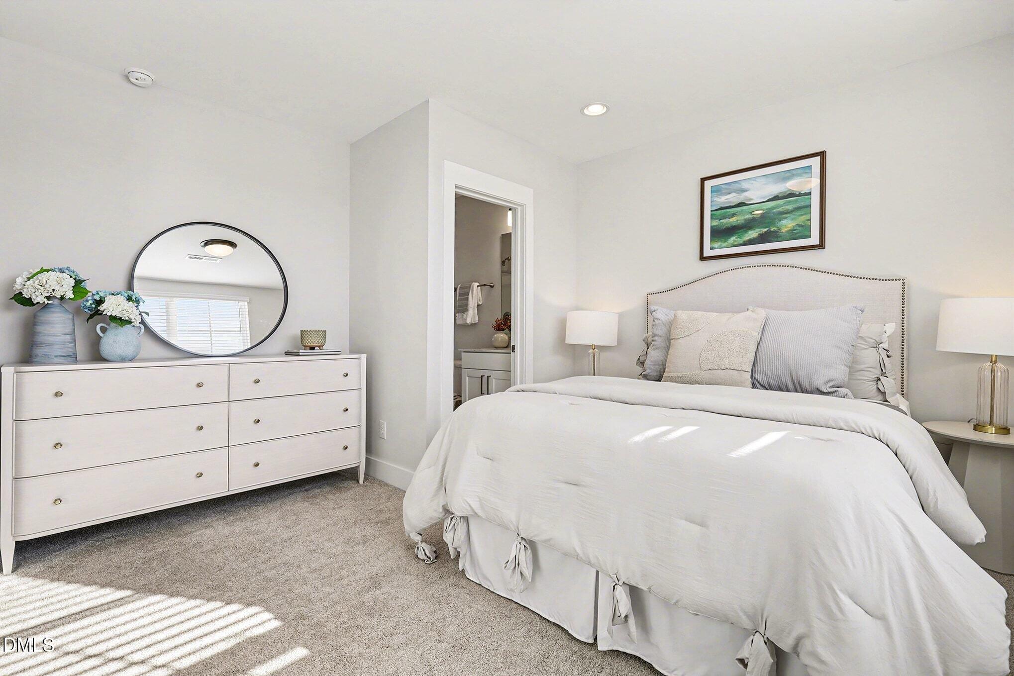 8512 Silsbee Drive Raleigh, NC 27613 - Photo 6 of 42 a bedroom with a bed a mirror on dresser and a dresser