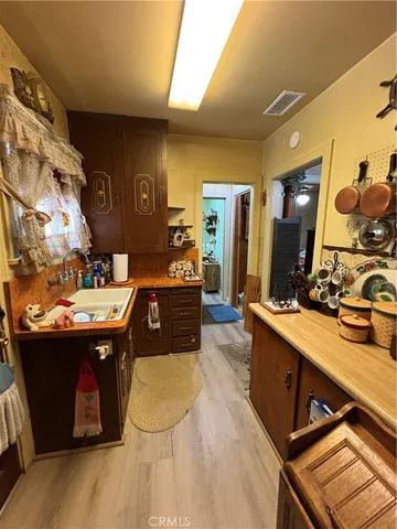 a kitchen with a sink appliances and cabinets