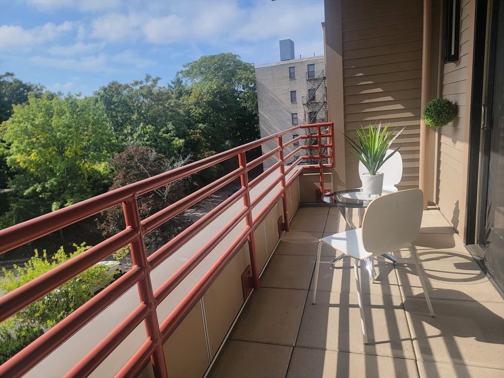 1650 Commonwealth Avenue, Unit 304A Boston, MA 02135 - Photo 14 of 26 a view of balcony with wooden floor and outdoor seating