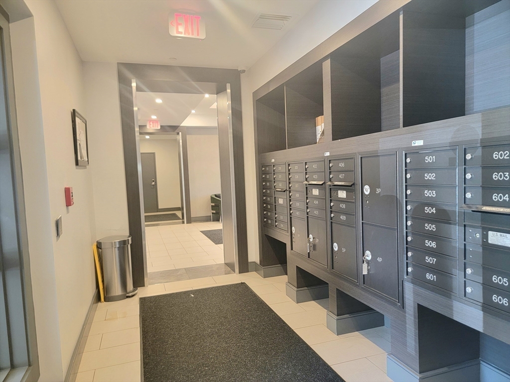 1650 Commonwealth Avenue, Unit 304A Boston, MA 02135 - Photo 21 of 26 a bathroom with a tub shower vanity and a sink
