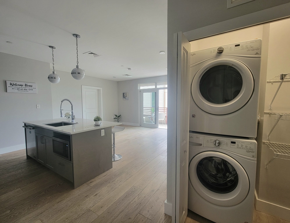 1650 Commonwealth Avenue, Unit 304A Boston, MA 02135 - Photo 8 of 26 a view of a kitchen with washer and dryer