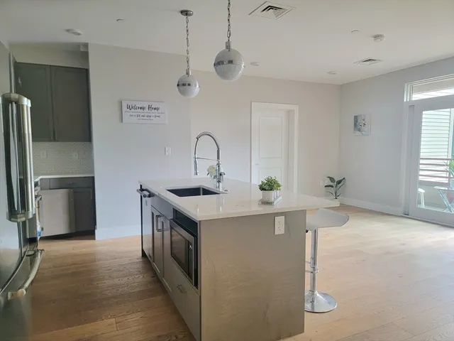 a kitchen with stainless steel appliances a sink and a refrigerator
