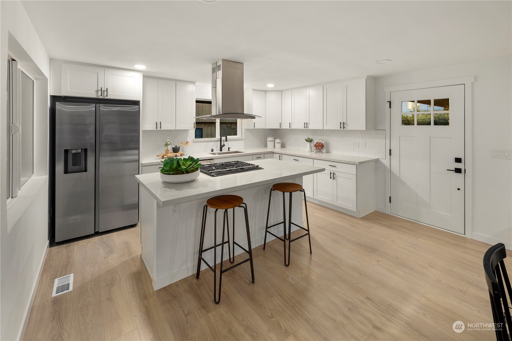 2823 South Bateman Street Seattle, WA 98108 - Photo 12 of 39 a kitchen with stainless steel appliances a table chairs refrigerator and sink