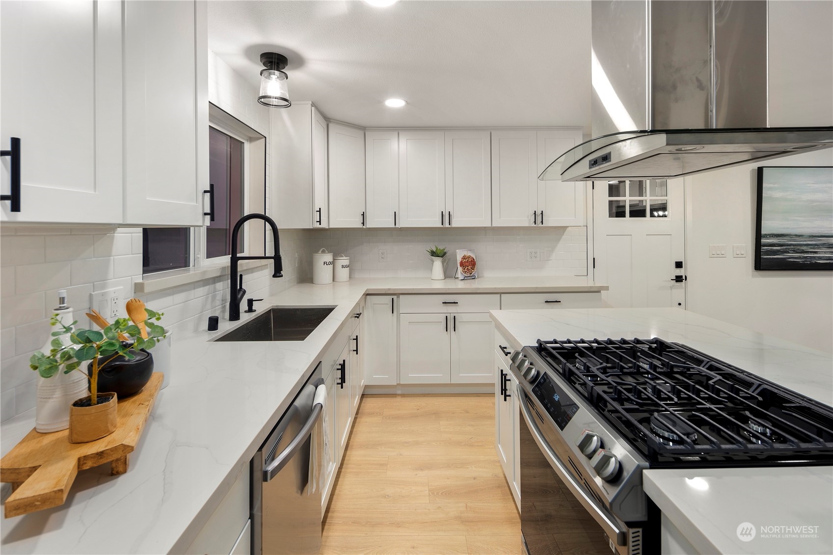 2823 South Bateman Street Seattle, WA 98108 - Photo 13 of 39 a kitchen with stainless steel appliances a sink a stove and cabinets