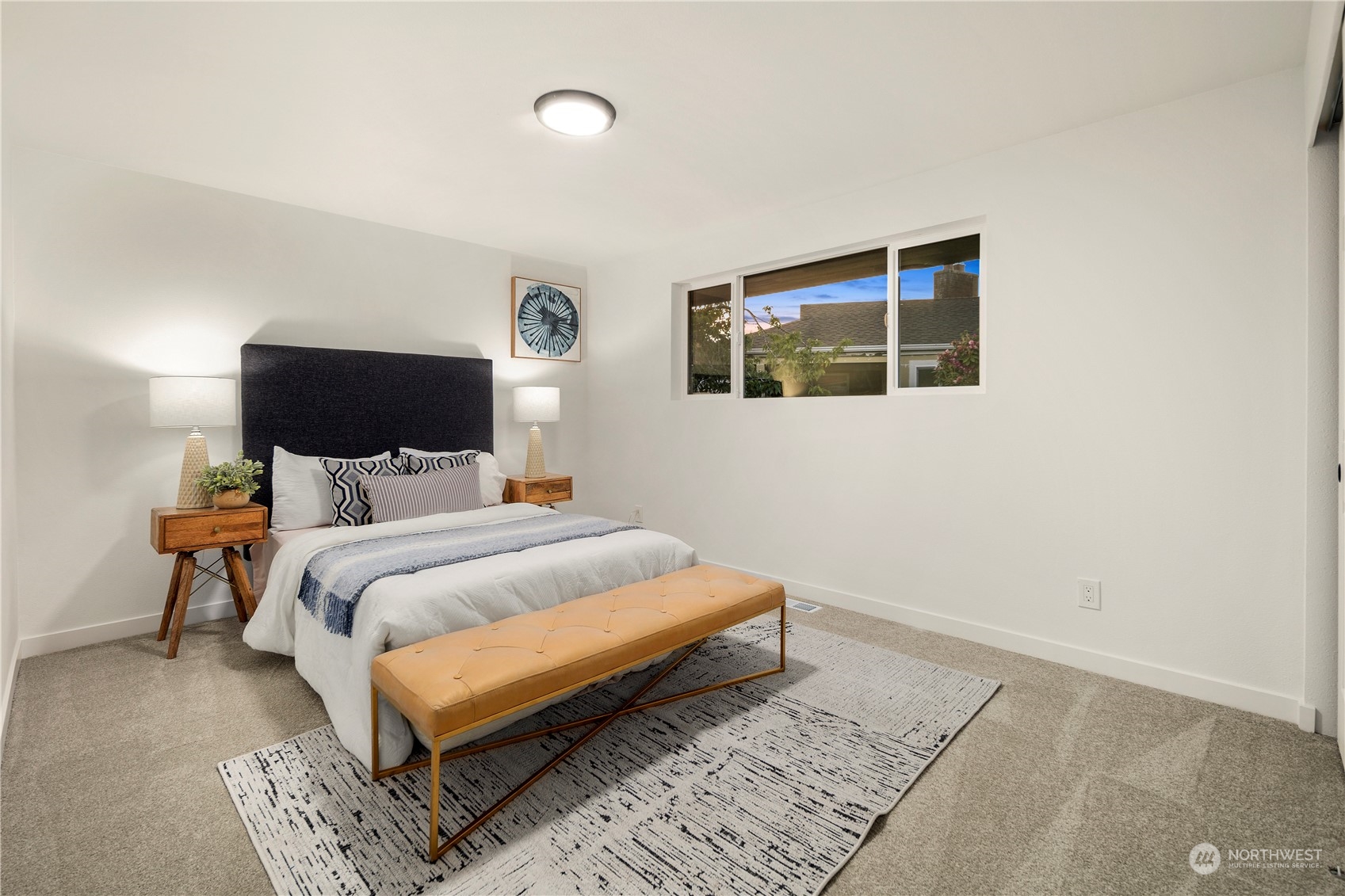 2823 South Bateman Street Seattle, WA 98108 - Photo 16 of 39 a bedroom with a bed and wooden floor