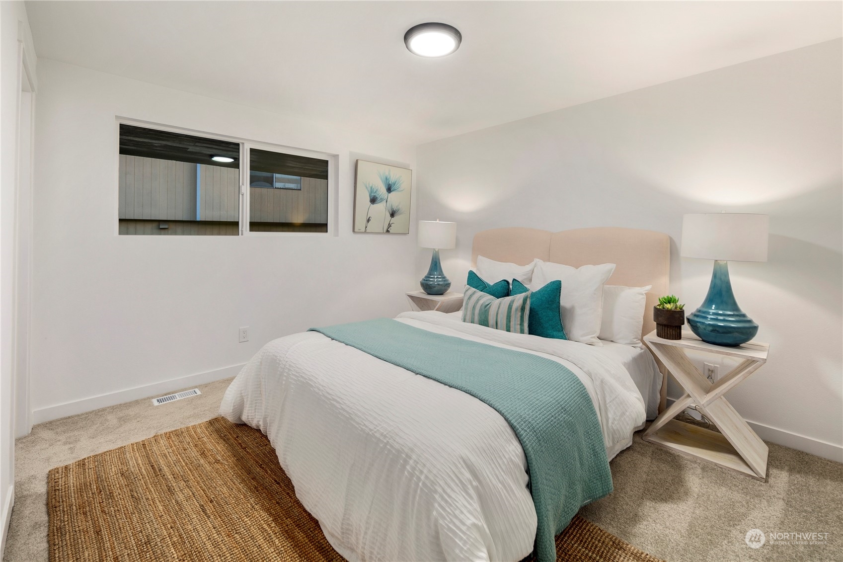 2823 South Bateman Street Seattle, WA 98108 - Photo 17 of 39 a bedroom with a bed and painting on the wall