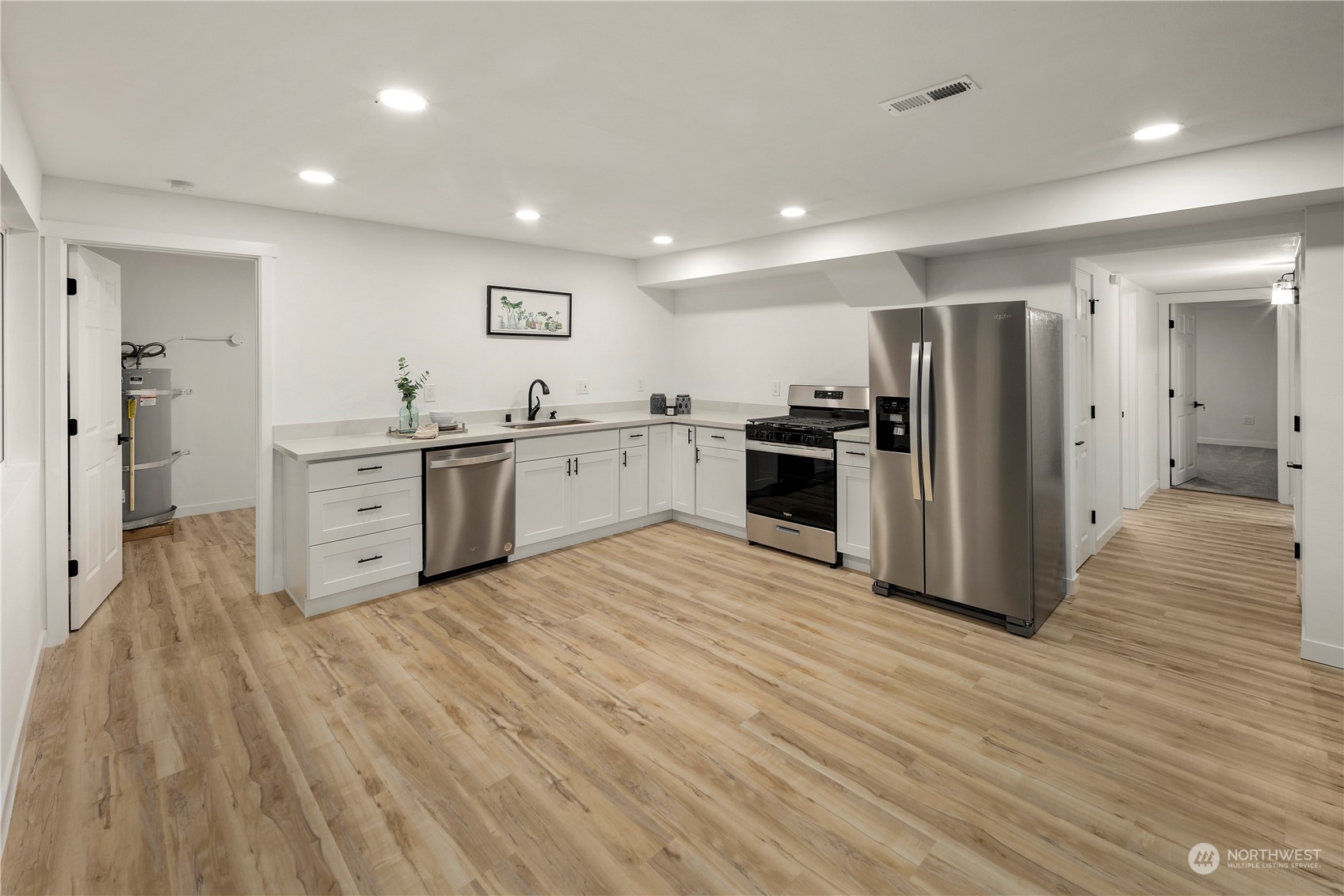 2823 South Bateman Street Seattle, WA 98108 - Photo 33 of 39 a large kitchen with stainless steel appliances granite countertop a stove and a refrigerator