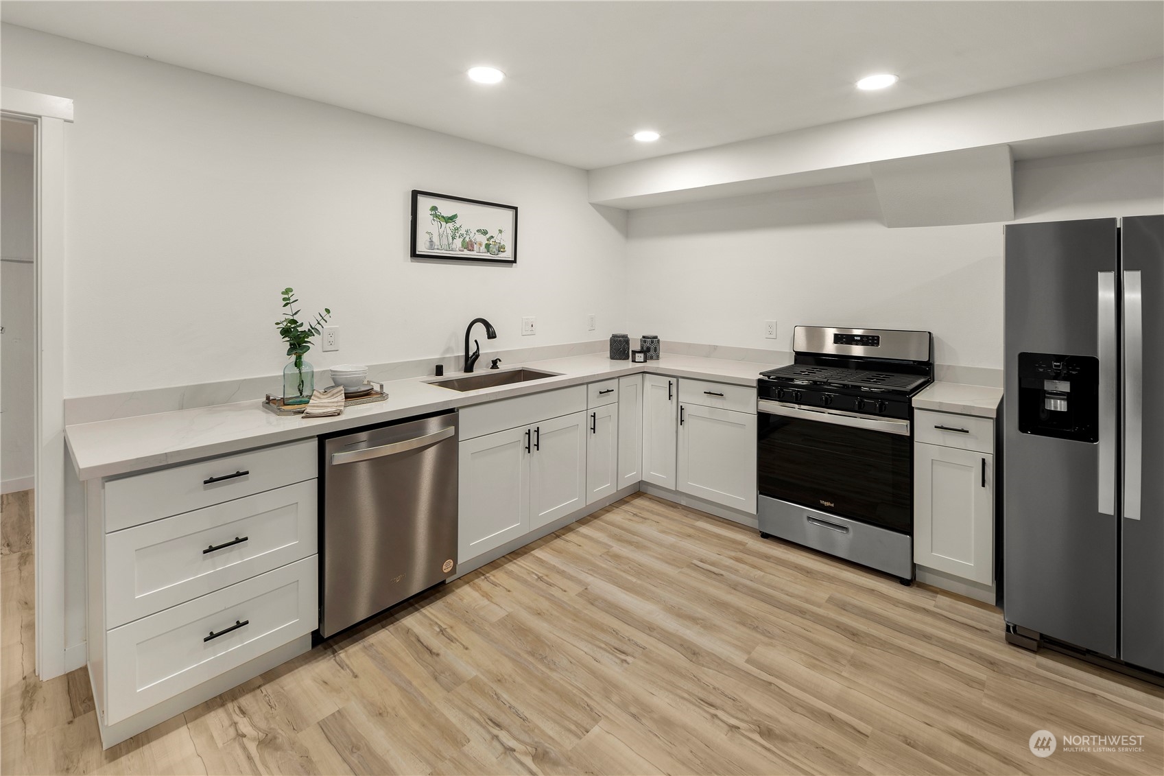 2823 South Bateman Street Seattle, WA 98108 - Photo 34 of 39 a kitchen with a sink cabinets and stainless steel appliances