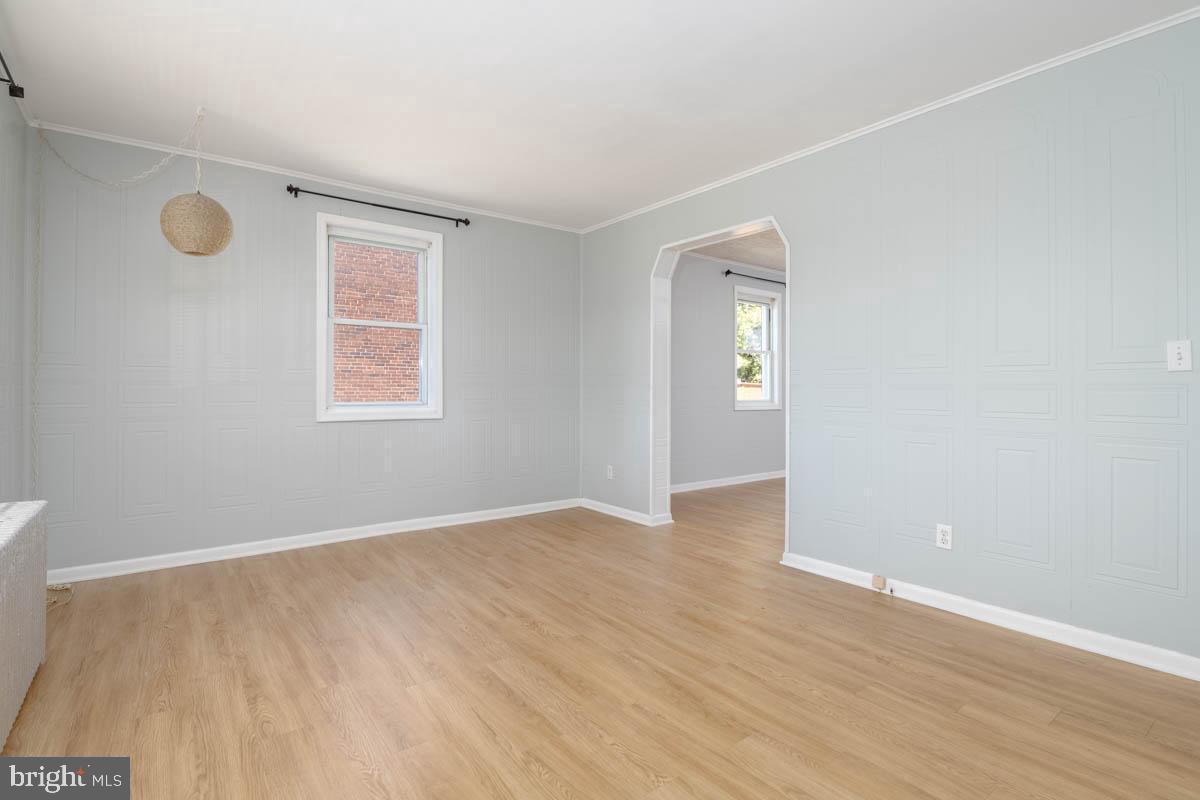 2475 Fairway Baltimore, MD 21222 - Photo 17 of 25 an empty room with wooden floor and windows