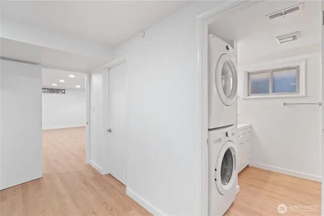 a view of a storage and utility room with washer and dryer