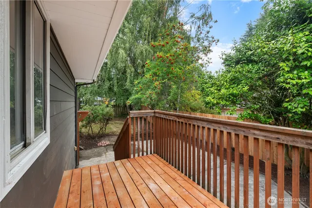 a balcony with wooden floor and outdoor space