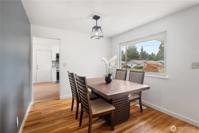 a view of a dining room with furniture window and wooden floor
