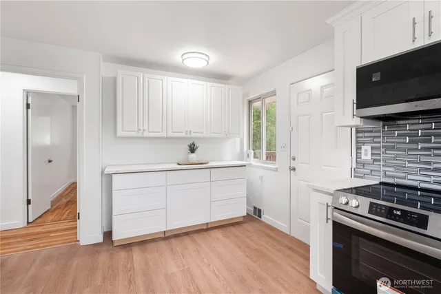 a kitchen with a stove and a microwave