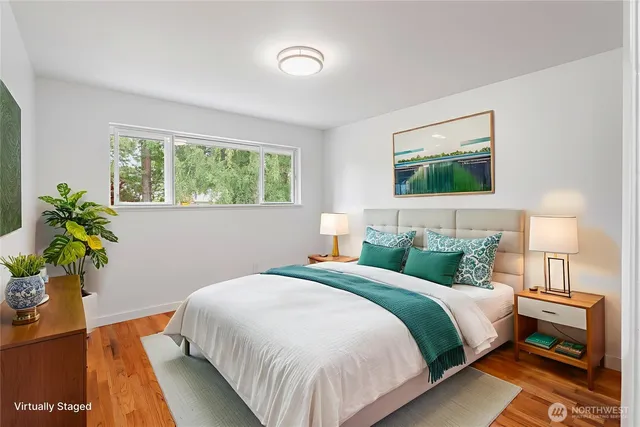 a bedroom with a bed and a potted plant