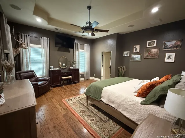 a bedroom with a bed a couch and dresser