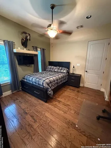 a bedroom with a bed and a couch