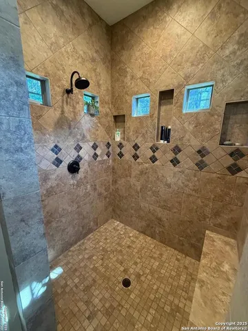a bathroom with a tub and a shower