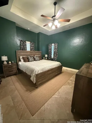 a bedroom with a bed and a chandelier
