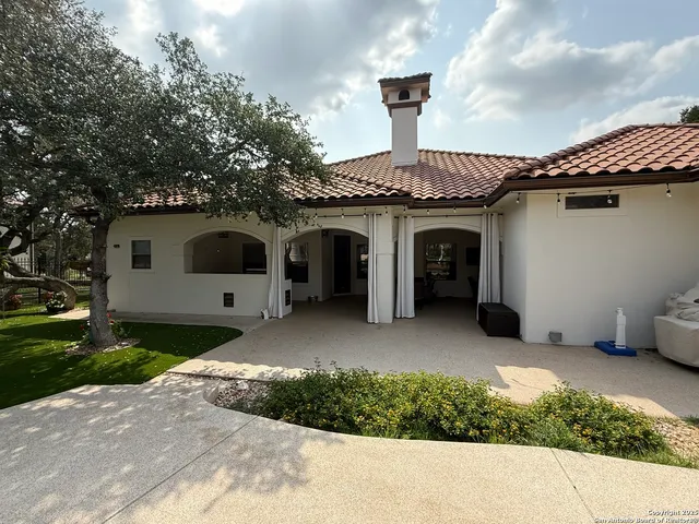 a view of a swimming pool with a yard and sitting space