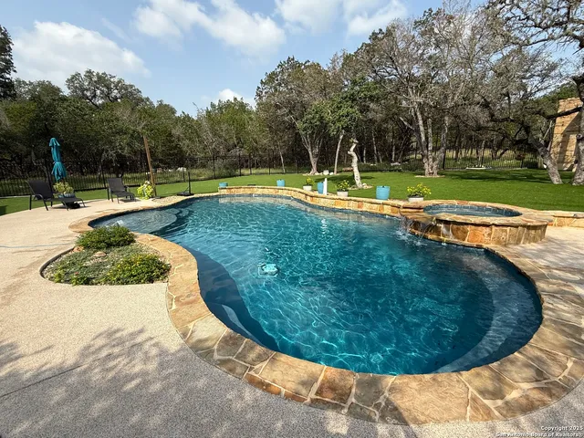 a view of a swimming pool with a patio
