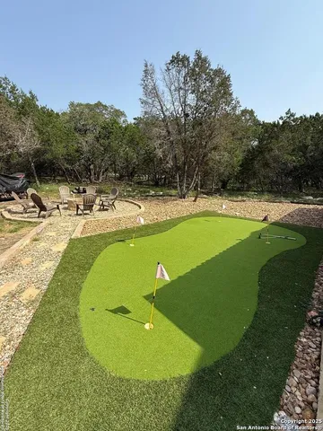 a swimming pool with outdoor seating yard and barbeque oven