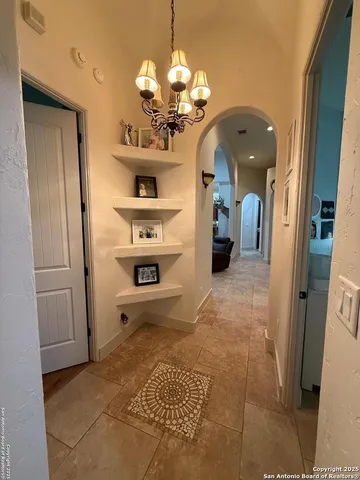 a view of a hallway with a chandelier