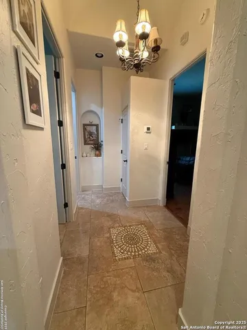 a view of a hallway with a chandelier