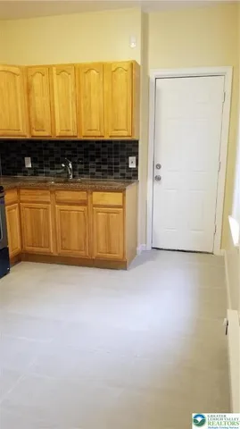 a view of a refrigerator with wooden floor