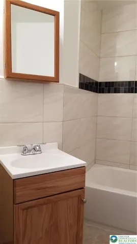 a bathroom with a toilet and a bathtub