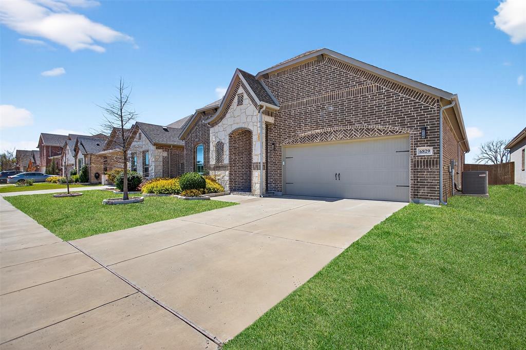 6829 Danridge Road Rowlett, TX 75089 - Photo 28 of 28 a front view of a house with garden