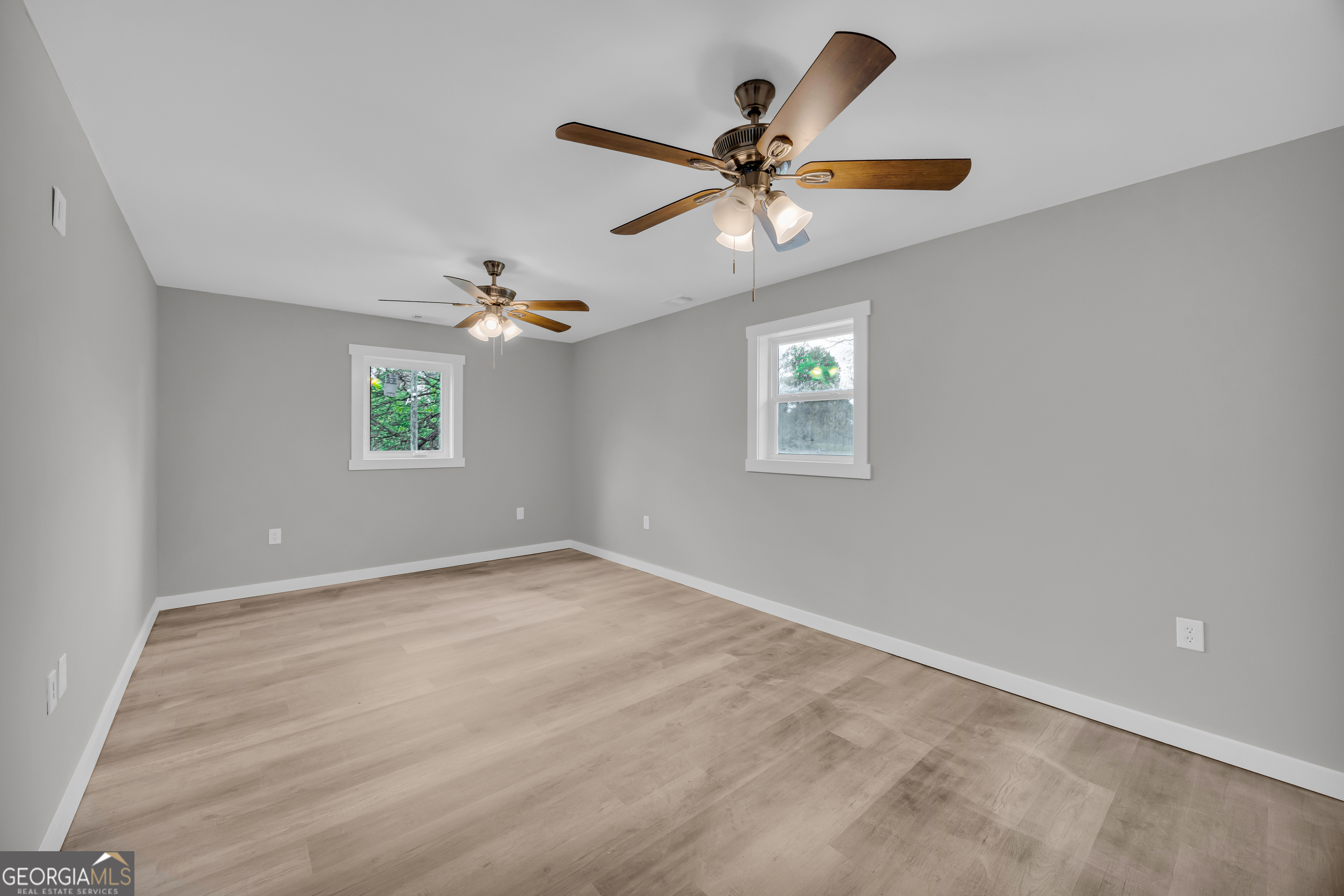 8606 Holly Springs Road Maysville, GA 30558 - Photo 64 of 74 an empty room with window and ceiling fan